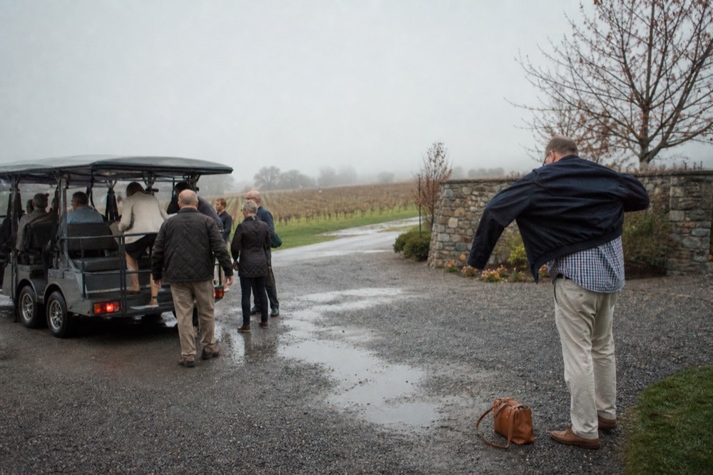 Guests boarding a small tour vehicle outside a Sonoma winery entrance, no text, no logos, no people