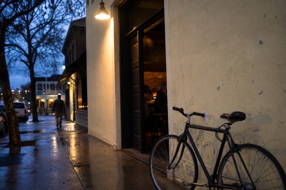 A side street near the Healdsburg plaza with a small unmarked tasting room doorway, no text, no logos, no people