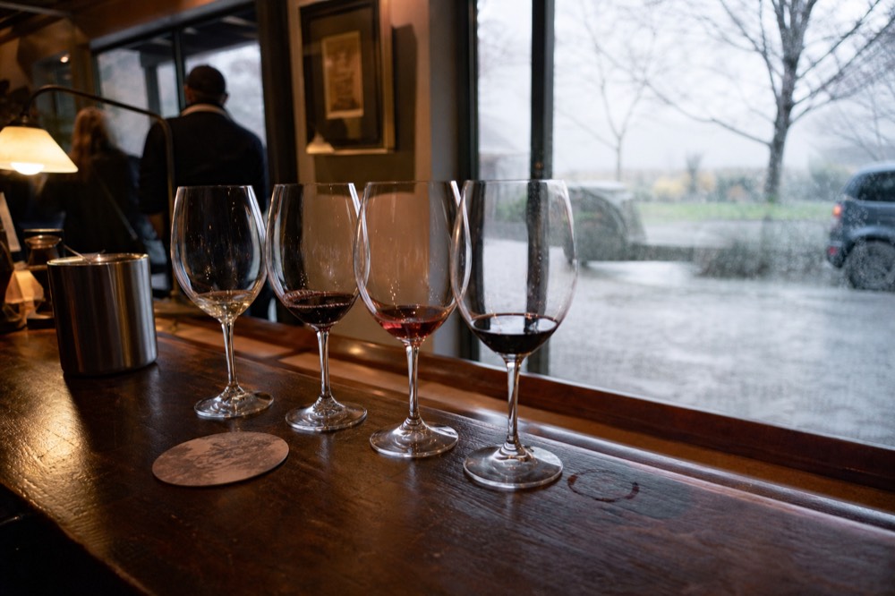 Wine glasses arranged on a tasting bar in a Sonoma County tasting room, no text, no logos, no people